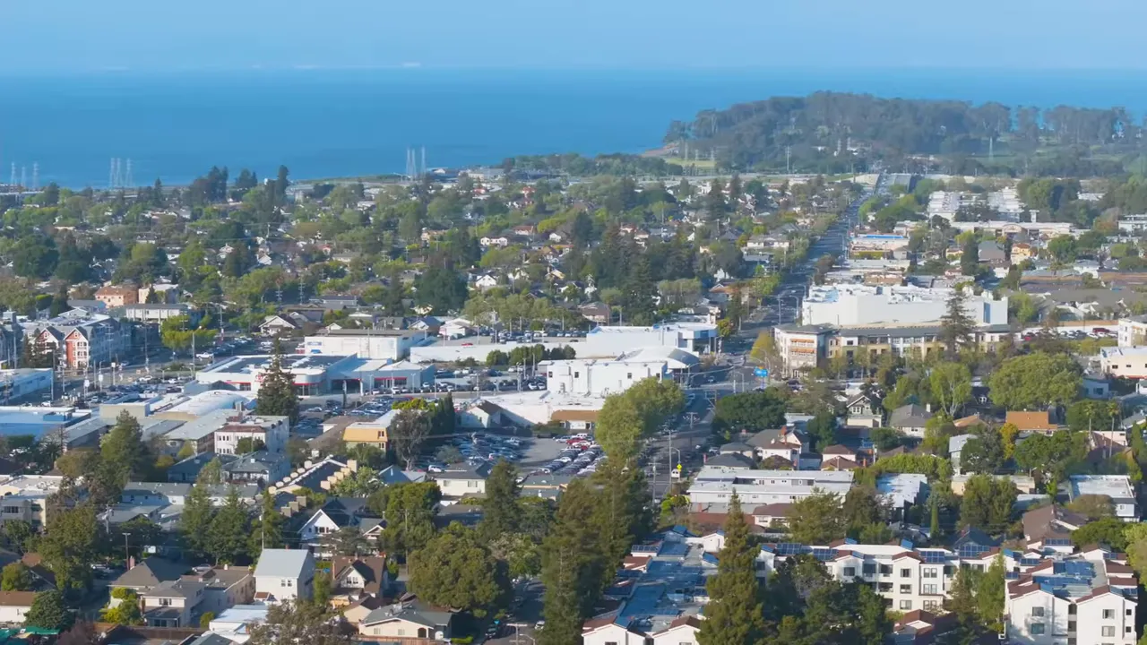 Aerial view of Bay Area neighborhoods with the ocean visible in the background