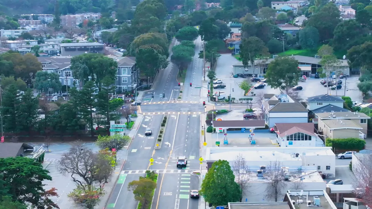 Aerial view of a Bay Area suburban neighborhood street crossing near retail buildings