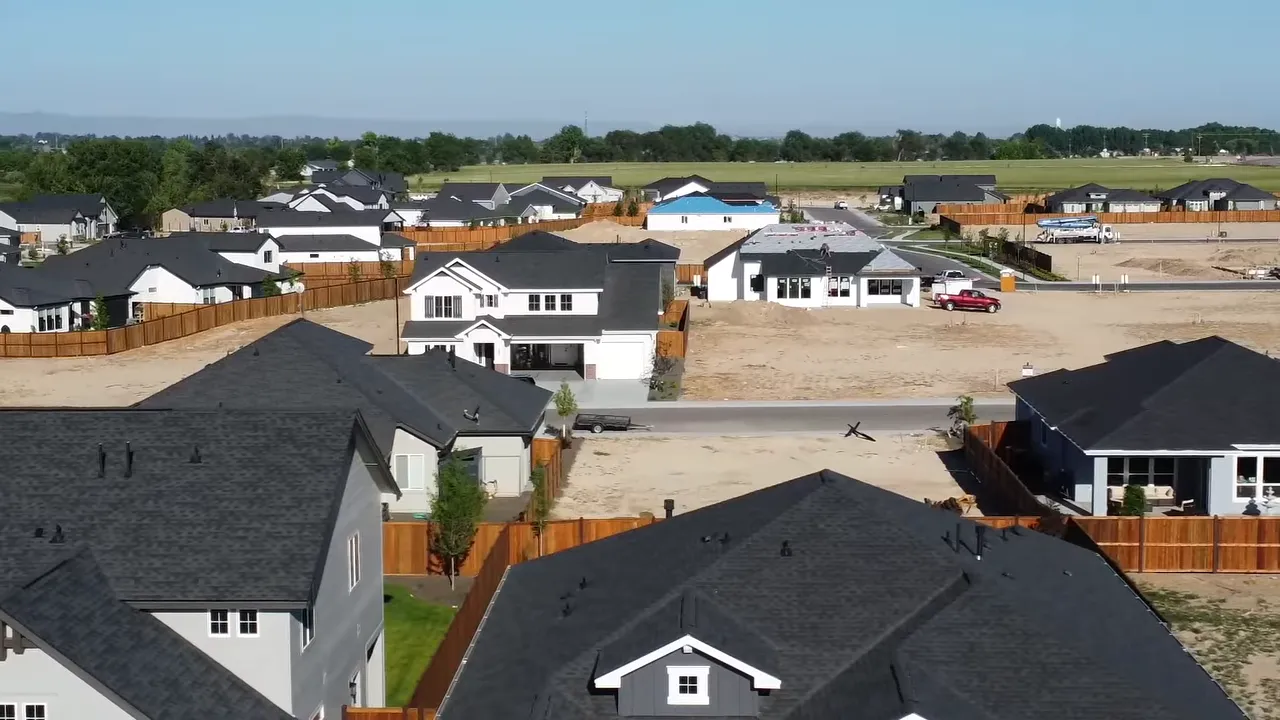 Newer homes with open lots and visible spacing between properties in expanding neighborhood