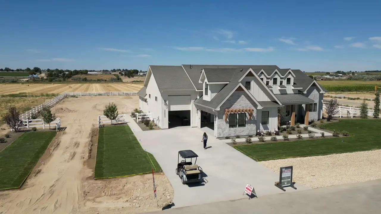 Large custom style home on wide lot with oversized driveway and multiple garage bays