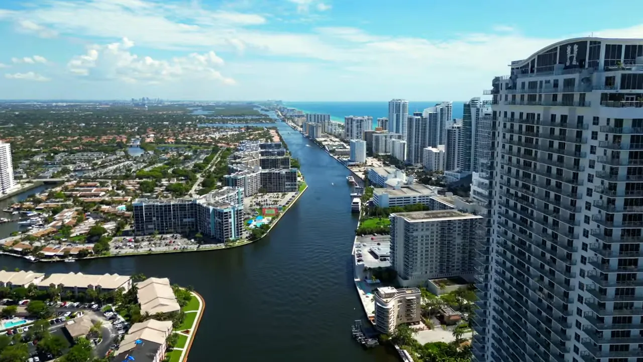 High-resolution aerial drone view of Palm Beach waterfront, canals, and high-rise condos.