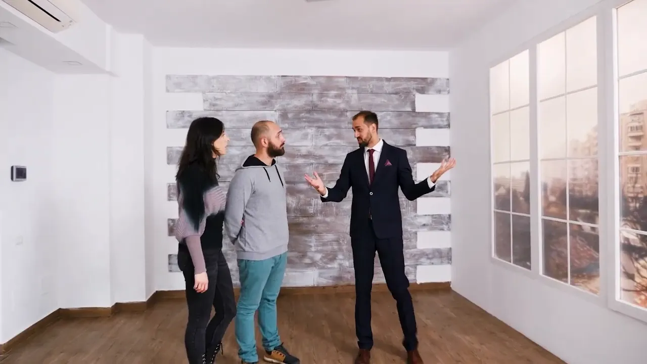 Real estate agent speaking with a couple