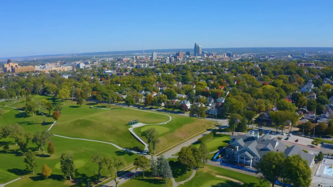 High-resolution aerial image of Downtown Omaha with parkland and residential areas leading to the downtown skyline