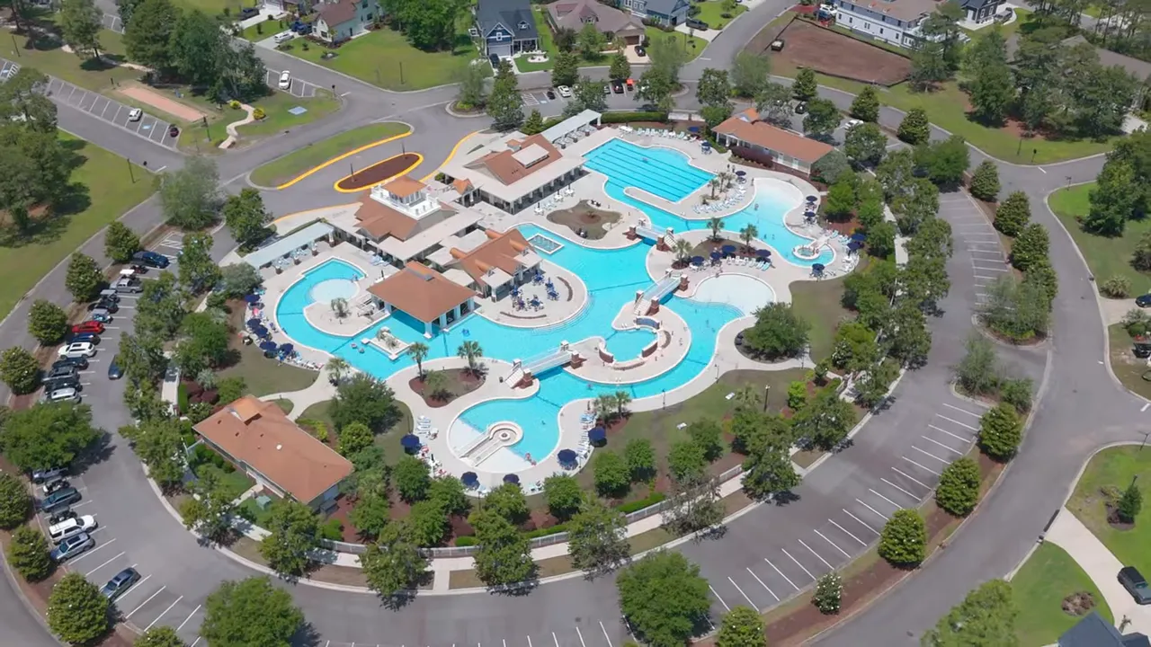 Aerial view of a completed neighborhood pool and surrounding homes