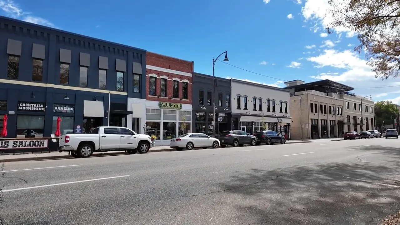 Downtown Loveland street with storefronts and parked cars