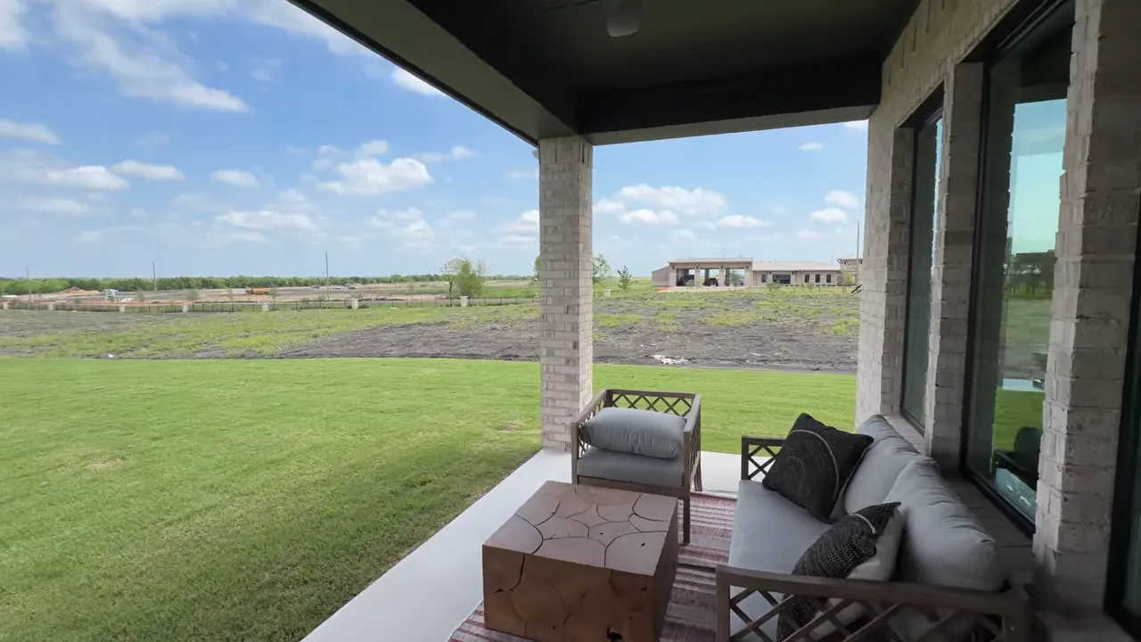 Primary suite outdoor seating area and covered porch in the Lancaster one-story home