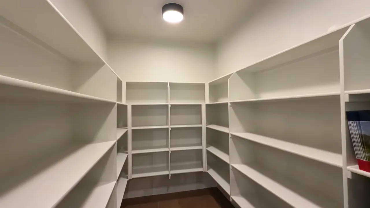 Wide view of pantry built-in shelves and compartments in Windsor Lancaster one-story home at Ridge Pointe Estates