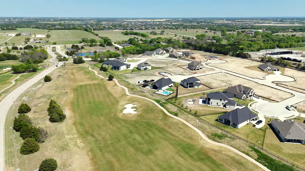 Aerial view of Heath Golf and Yacht Club golf course lots with homes and green space