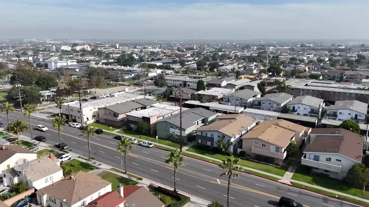Single-story homes with lawns and driveways on a Hawthorne residential street