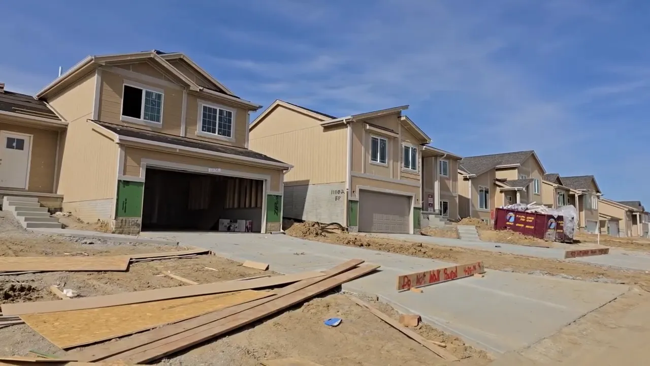 Row of partially built split entry homes on a construction street