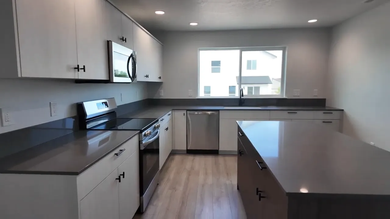 CBH new construction model kitchen in Thunderbolt Landing with modern cabinets, countertops, and appliances