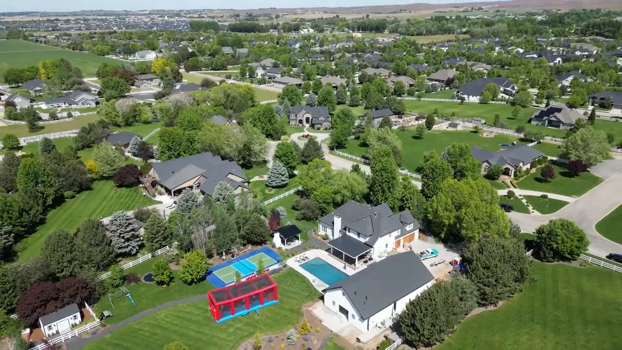 Aerial view of large homes on spacious green lots