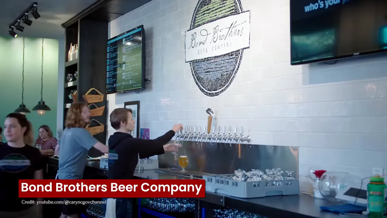 Bond Brothers Beer Company bar counter with tap handles and a customer preparing to pour a drink in Cary, NC