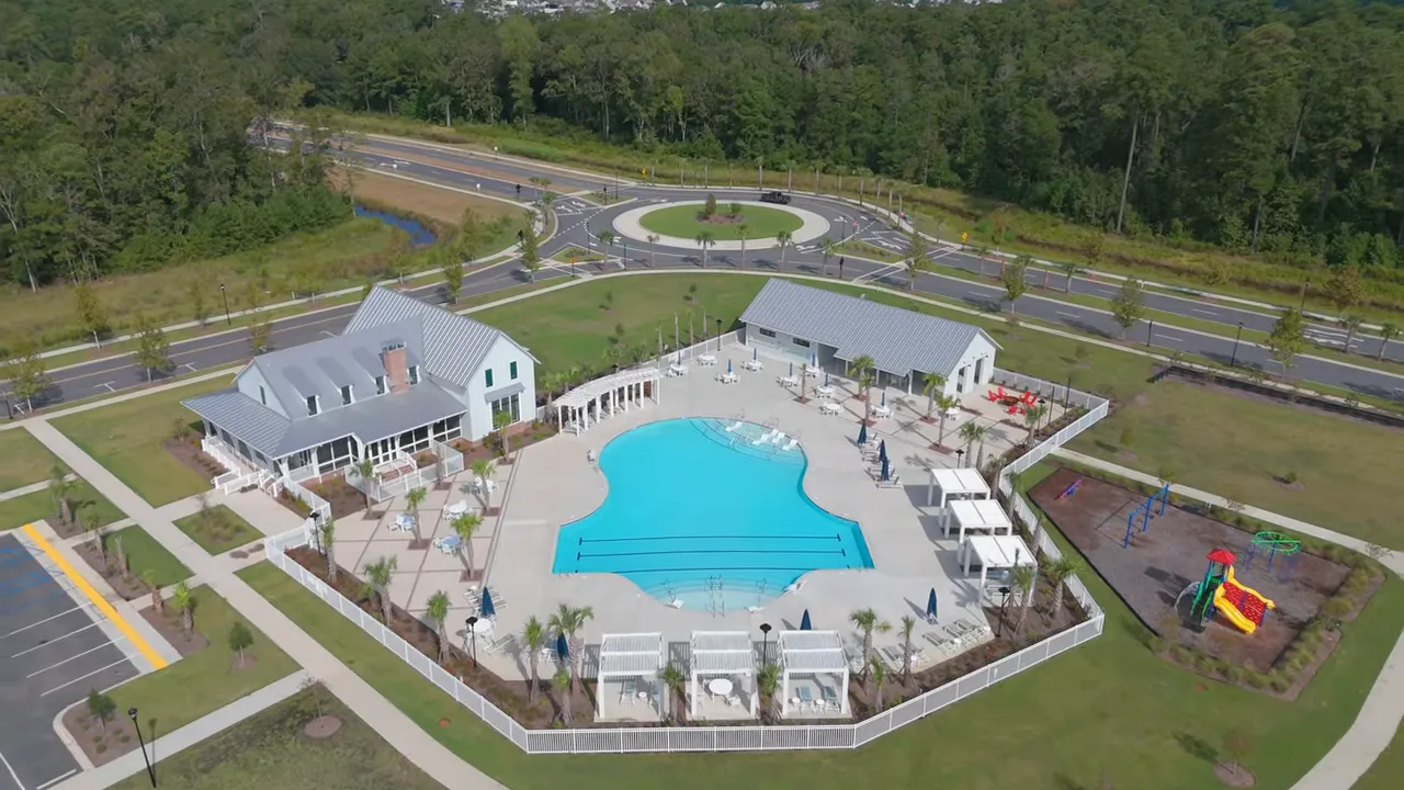 Aerial view of community pool and surrounding homes