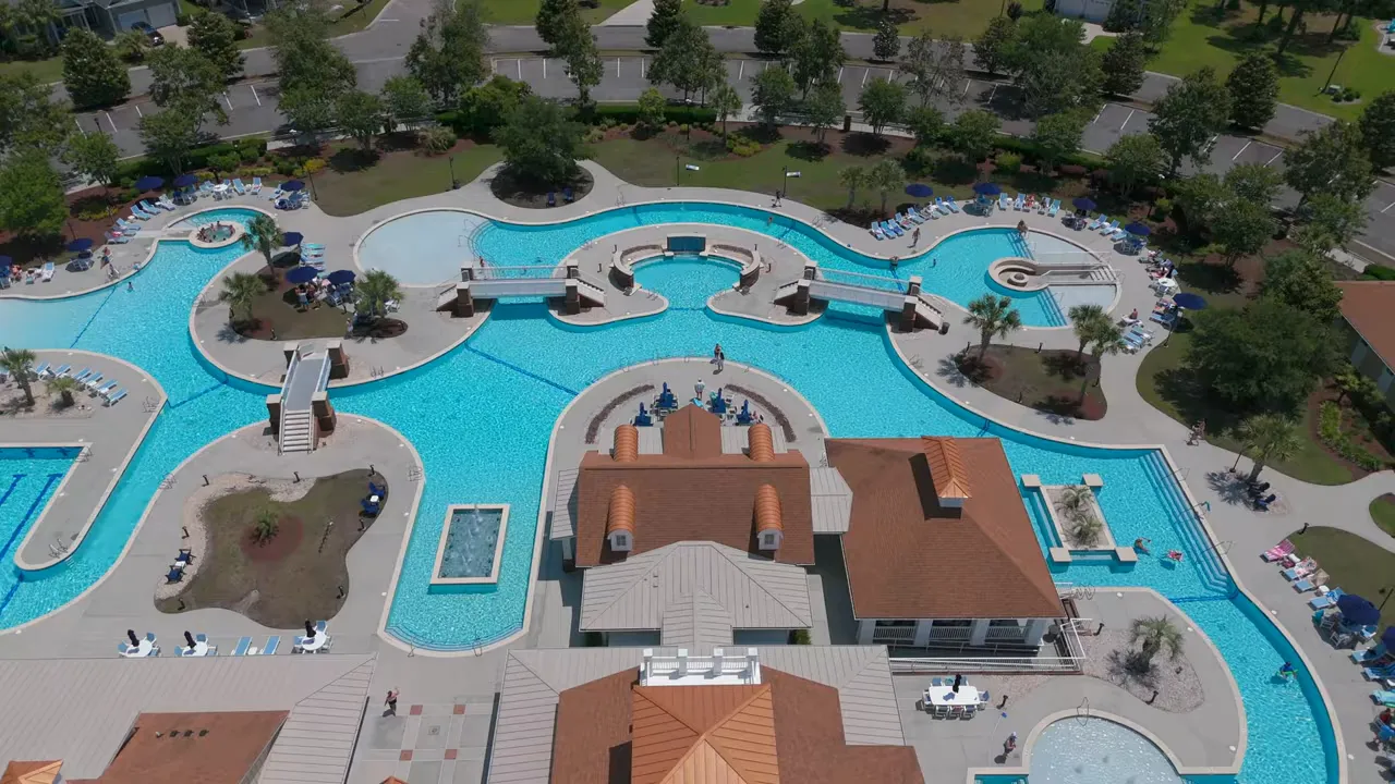 Aerial view of interconnected resort pools and clubhouse