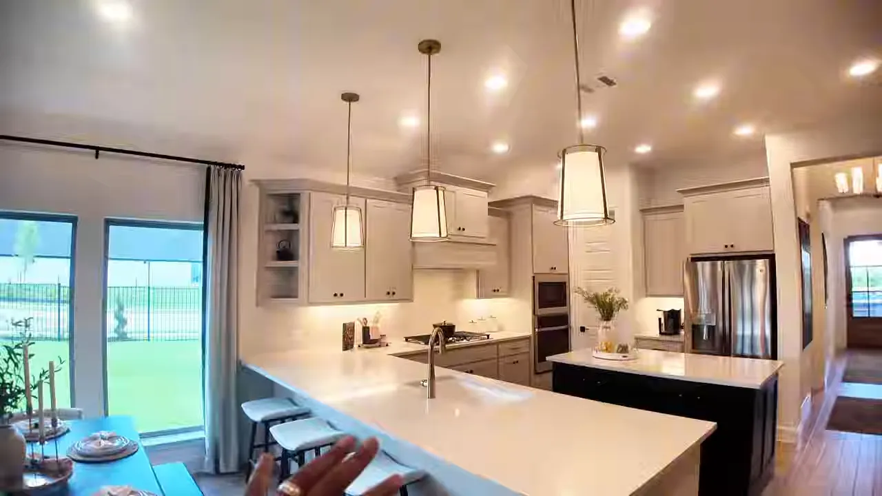 Bright kitchen with large island pendant lights white cabinets and bar stools