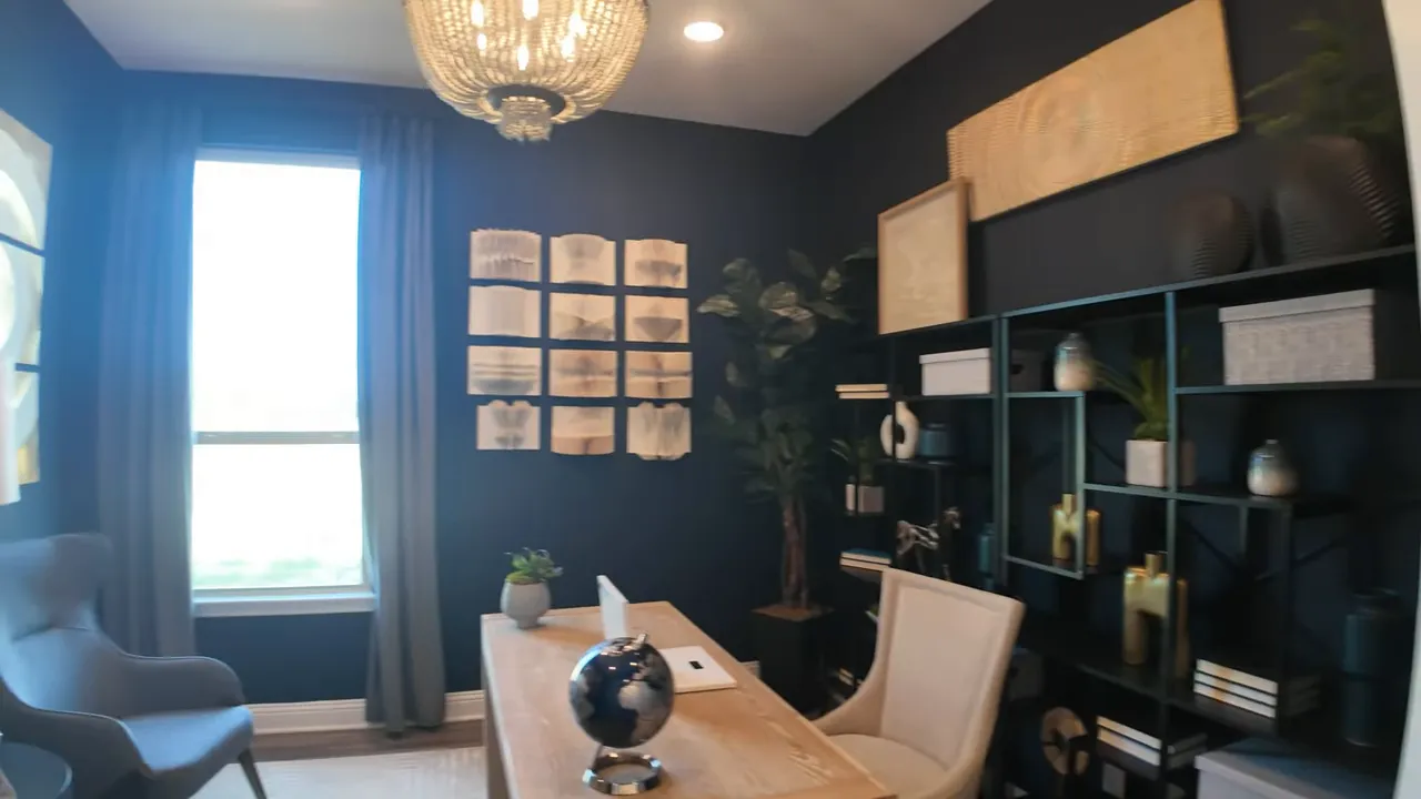home office with desk chairs dark walls and wall art