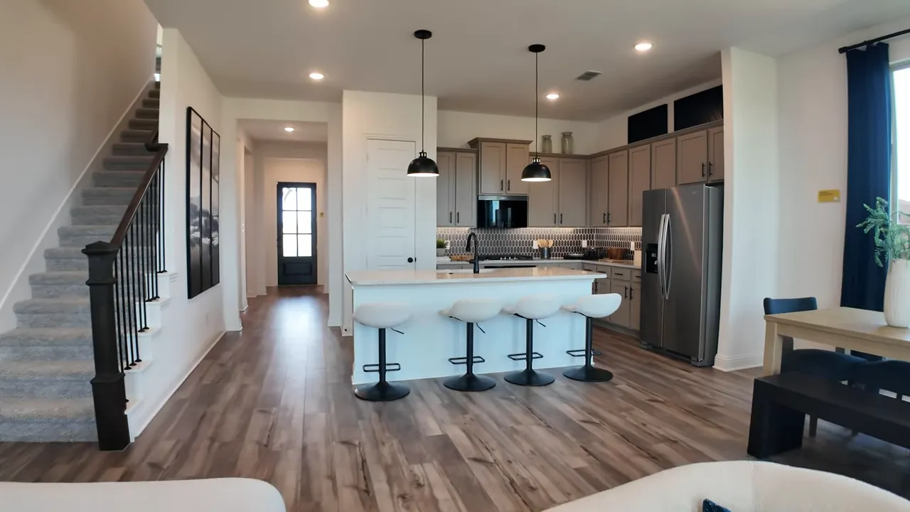 open concept living area with staircase kitchen island dining table and family room