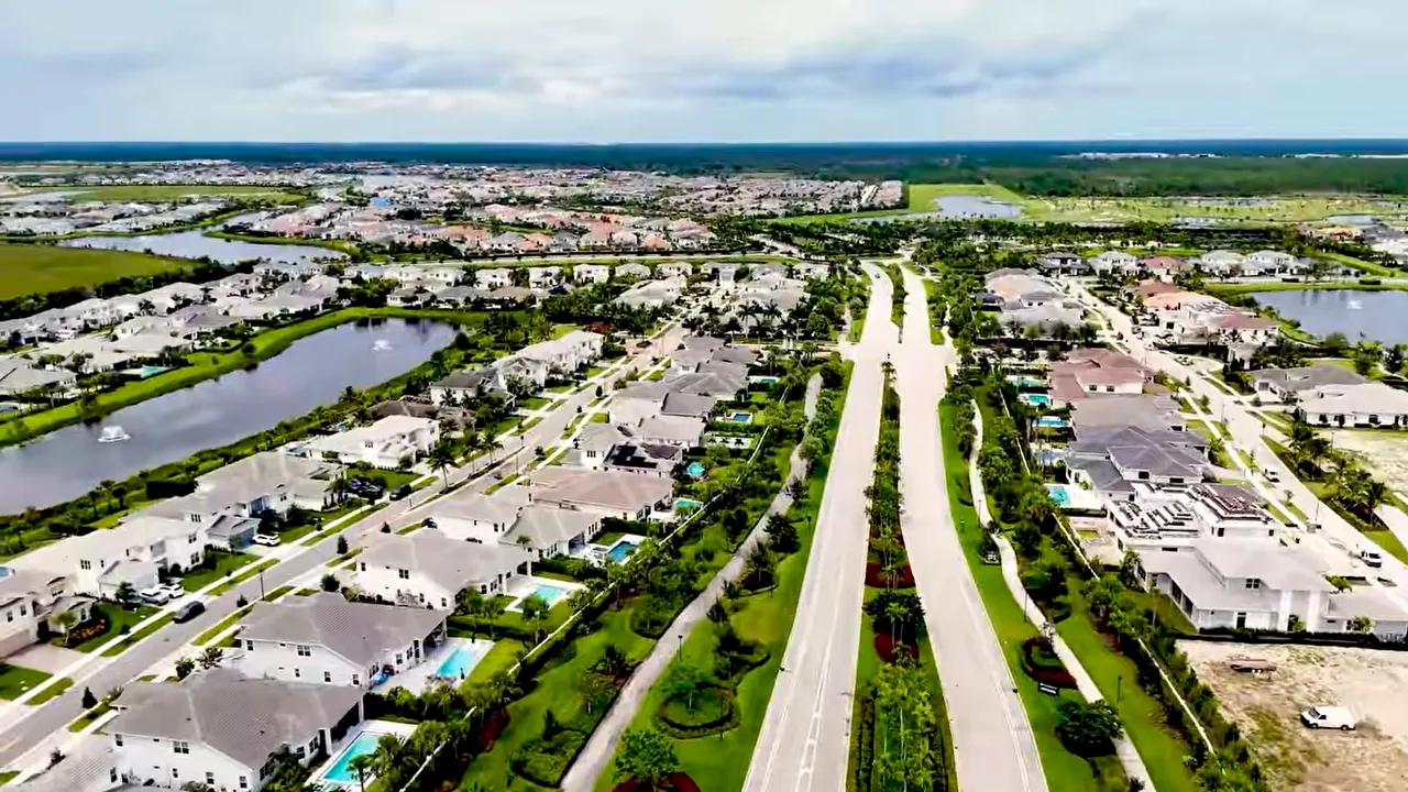 Aerial view of a South Florida active adult community with lakes and internal road layout