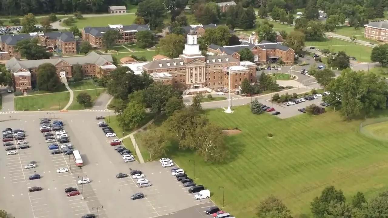 Aerial view of a school campus with buildings, parking lots, and athletic grounds