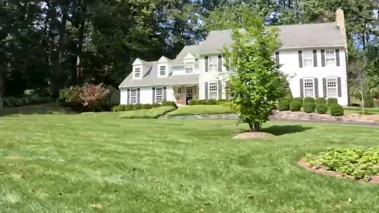 Large home exterior with manicured lawn in Bernardsville or Bernards Township