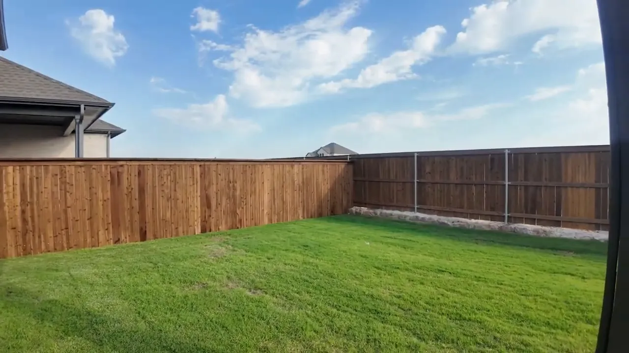 Large fenced backyard view from a Highland inventory home in Creekshaw, Royse City TX