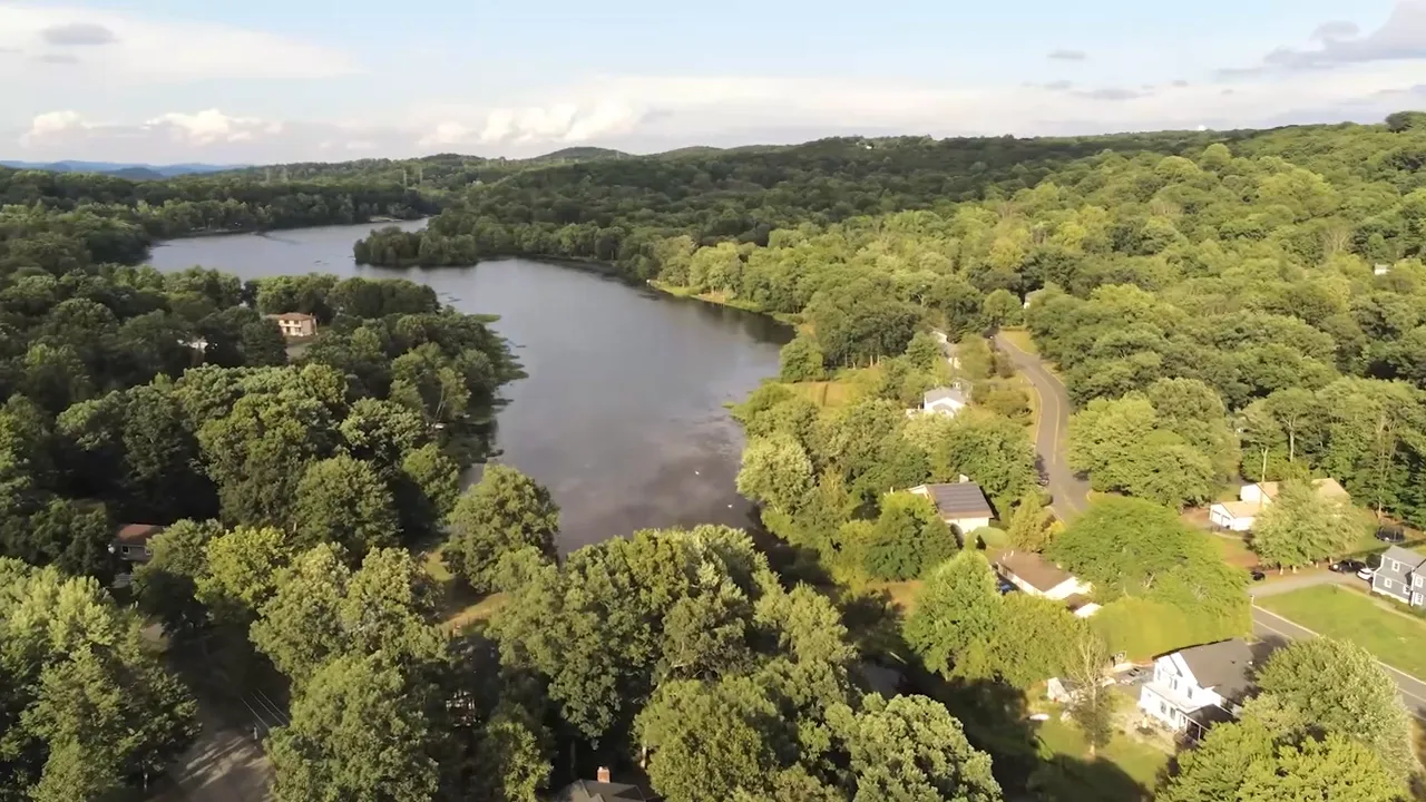 Aerial view of Shongum Lake surrounded by trees and homes