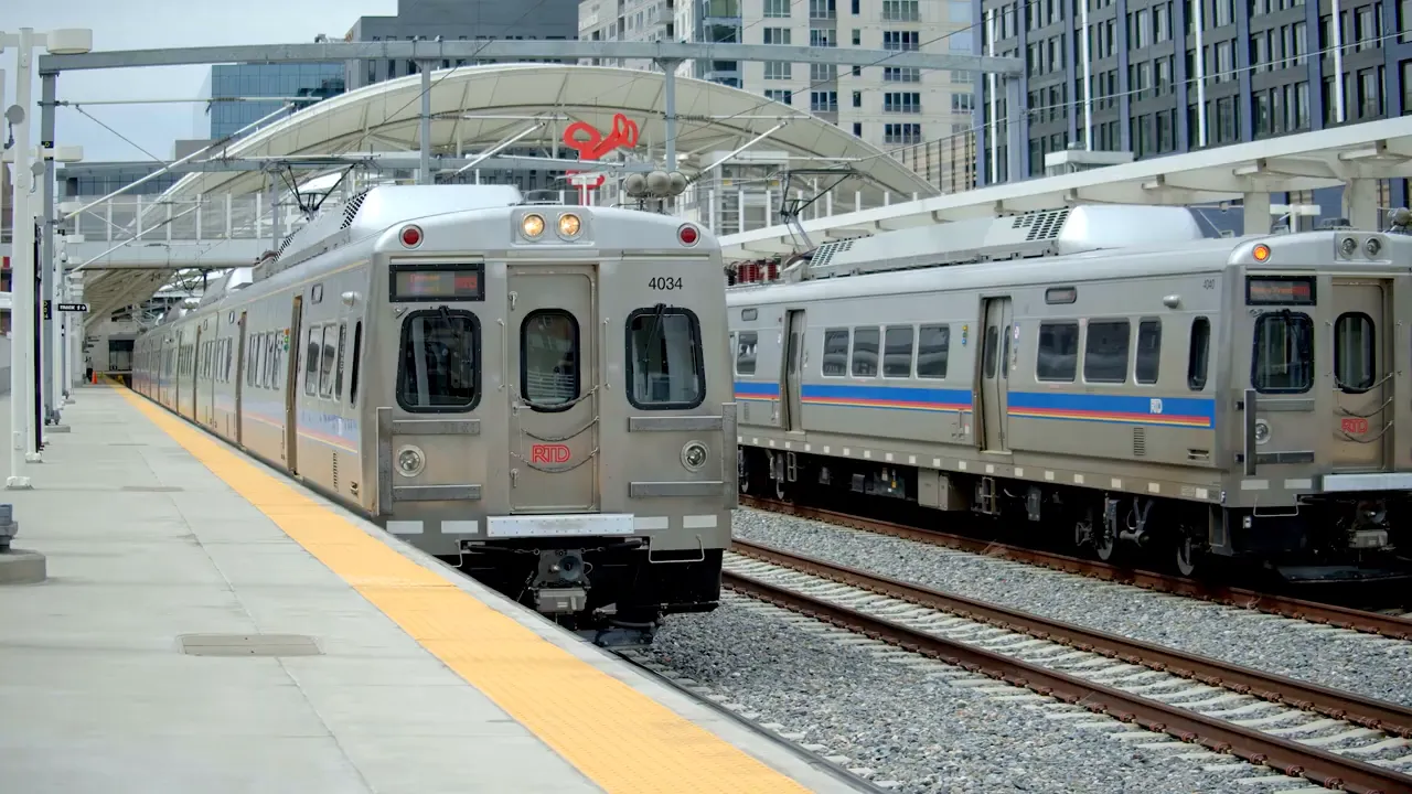 Passenger train stopped at a station platform representing commuting and travel access for Lafayette CO
