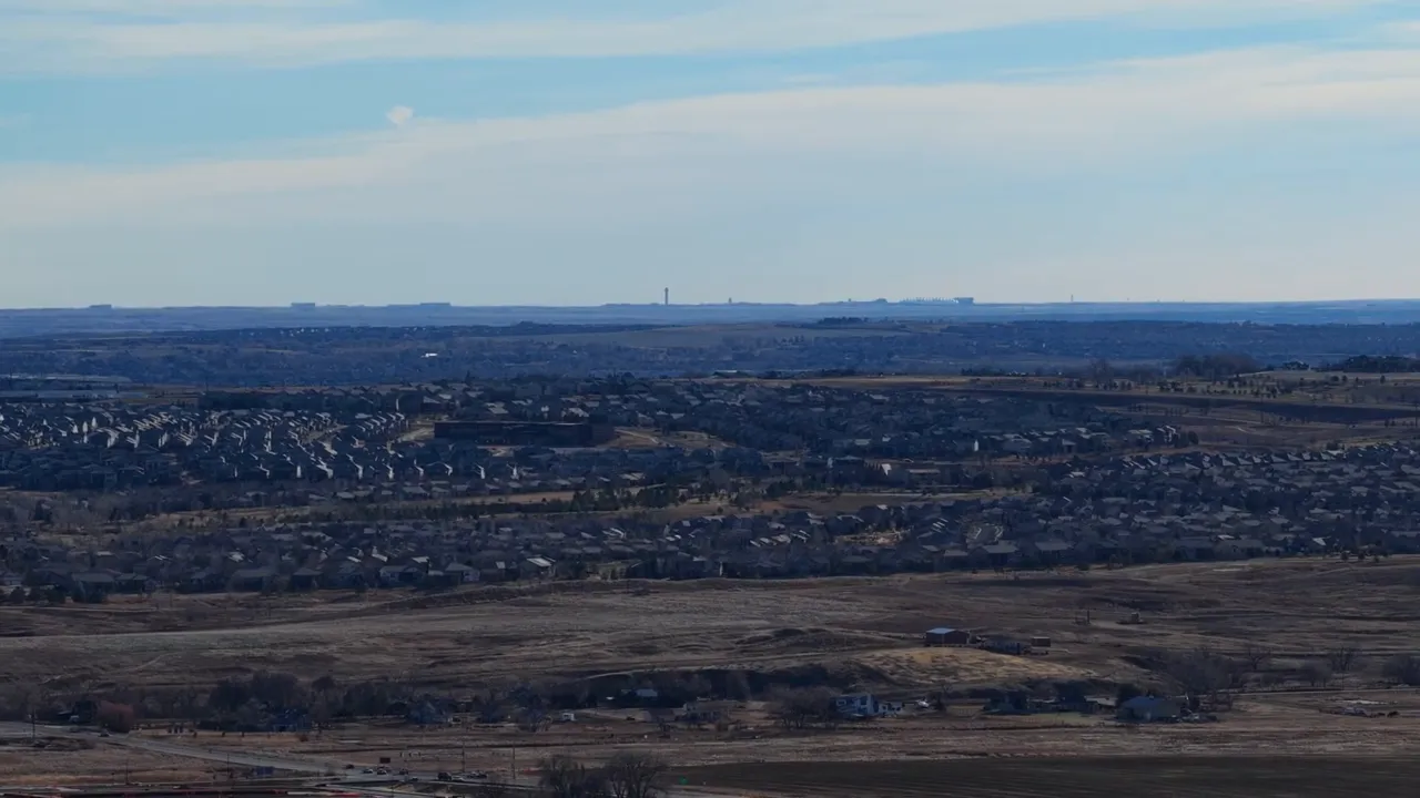 Wide aerial view of Lafayette CO with neighborhoods and open land