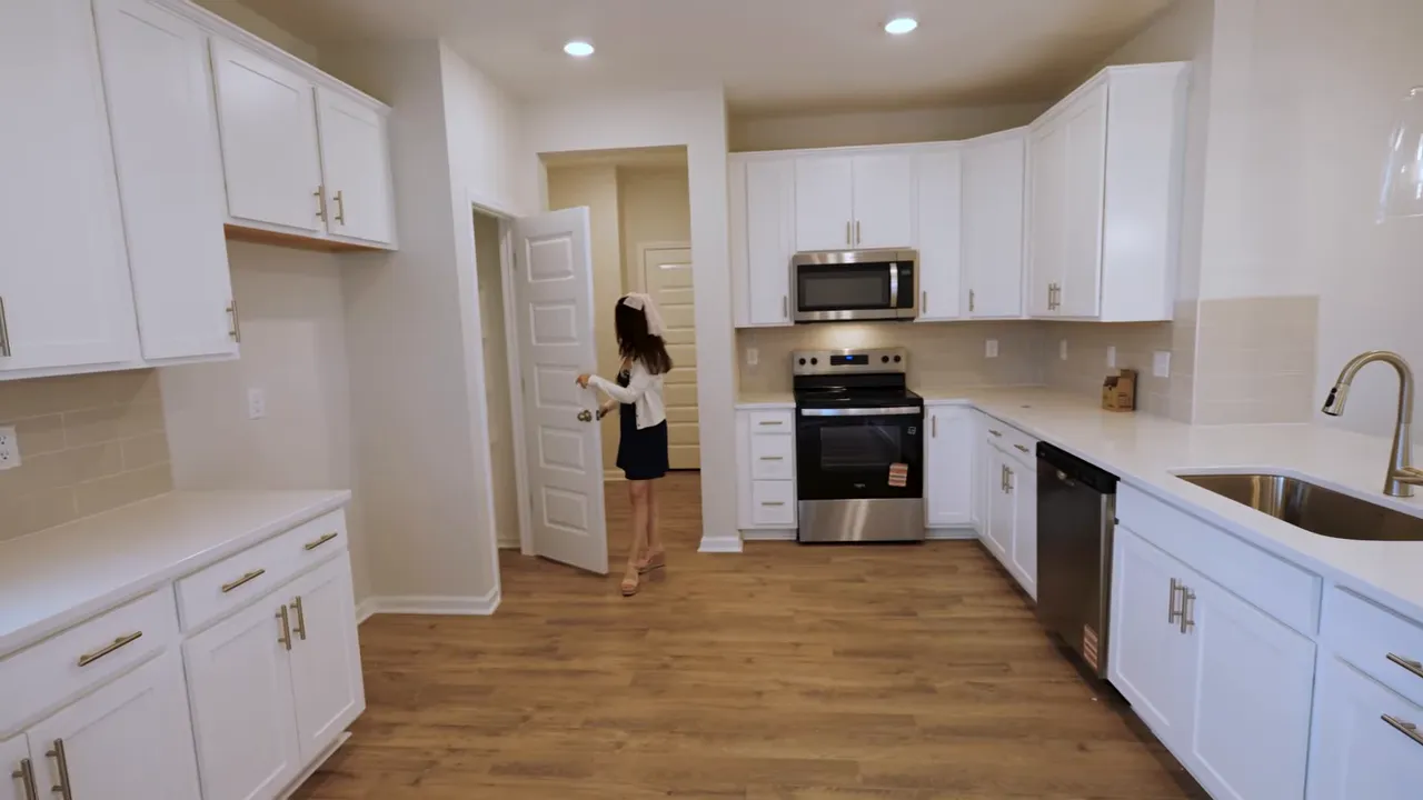 New construction kitchen in Conway SC with island, stainless appliances, and open dining-living sightline