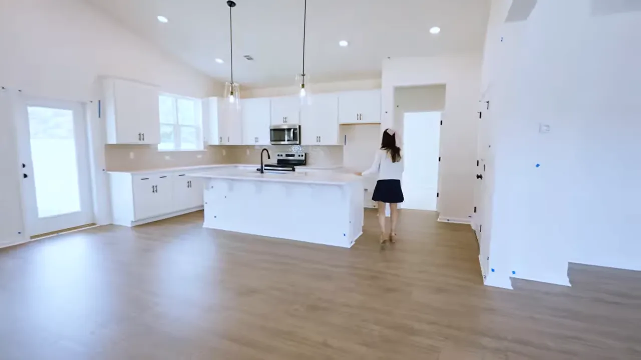 Wide view of kitchen island with pendant lights in Home 3 new construction Conway SC