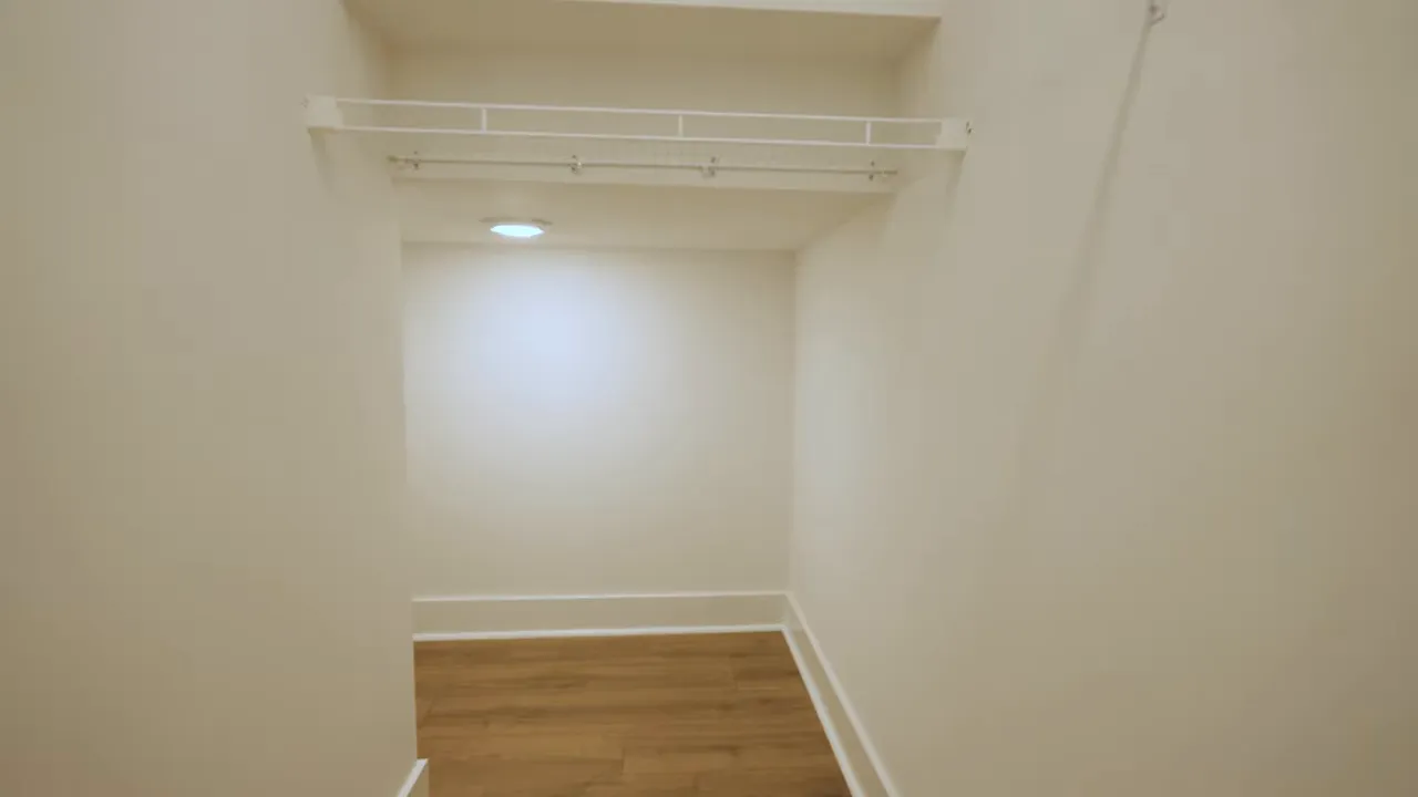Storage closet interior with shelving and hanging area in new construction home
