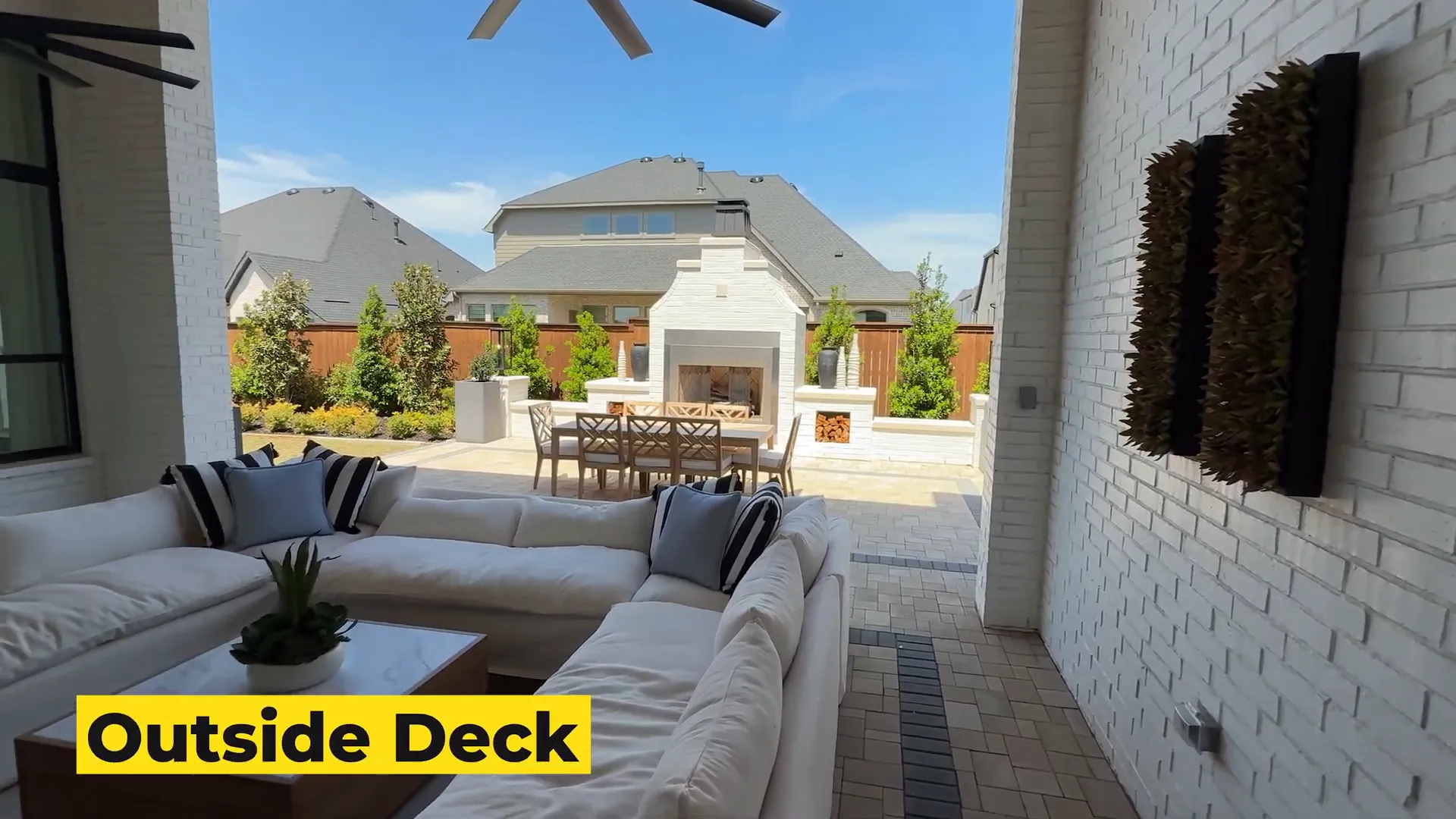 Backyard with seating area, fans, and fireplace