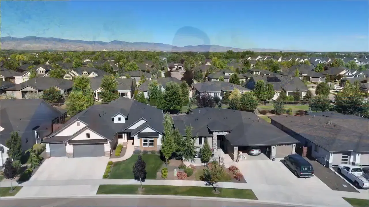 Aerial view of a Meridian Idaho neighborhood with single-family homes, driveways, and tree-lined yards