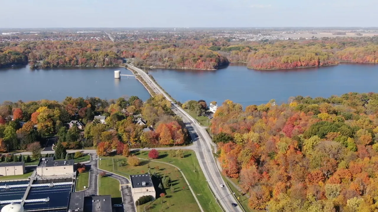 Bridge crossing Eagle Creek reservoir with colorful fall trees on both sides