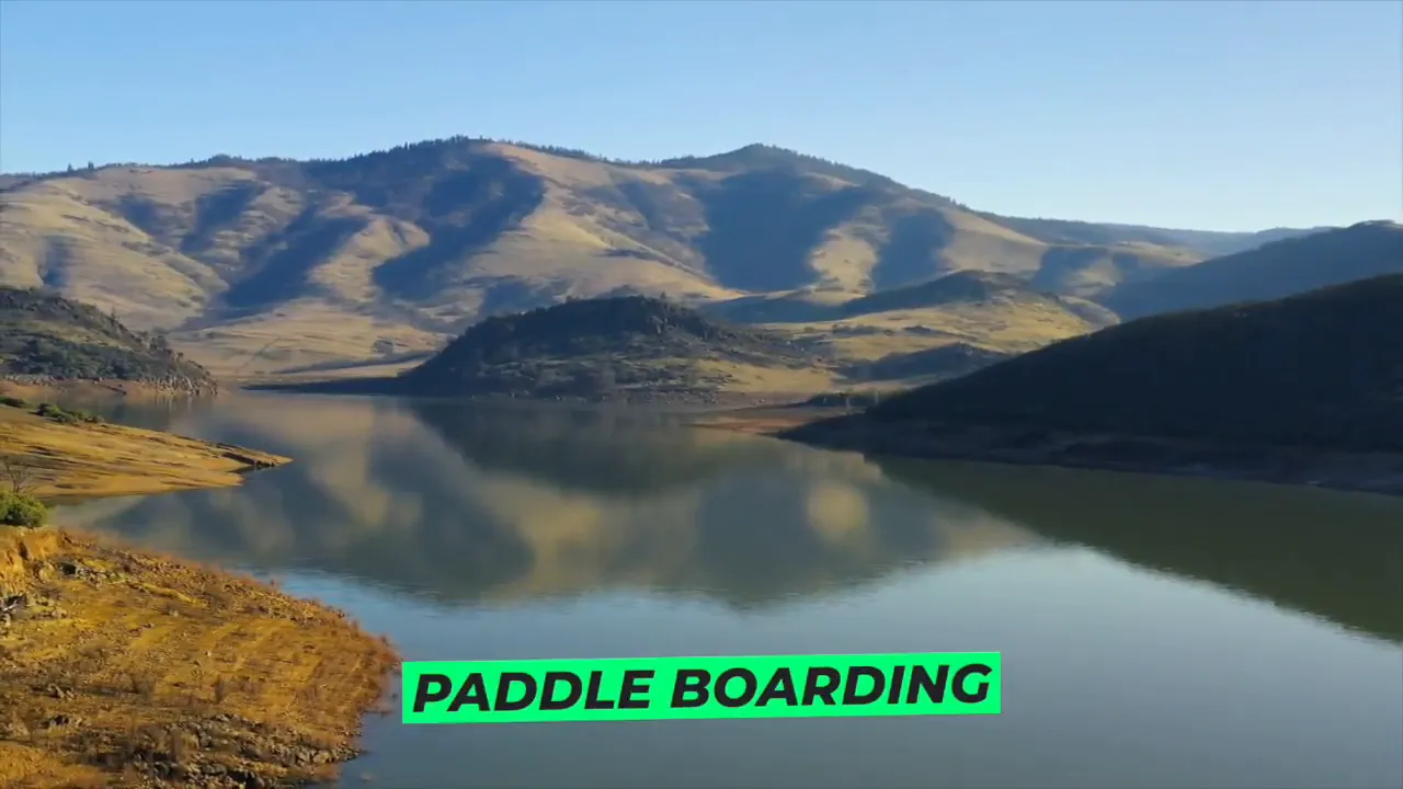 Emigrant Lake with mountains reflected in the water and paddle boarding text