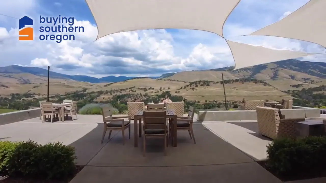 Patio seating at vineyard with shade sails and mountain views