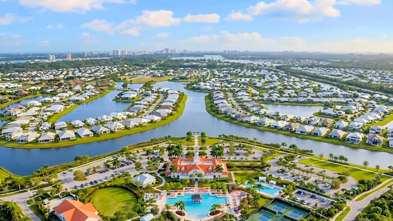 Wide aerial view of waterways homes clubhouse and pools in the community