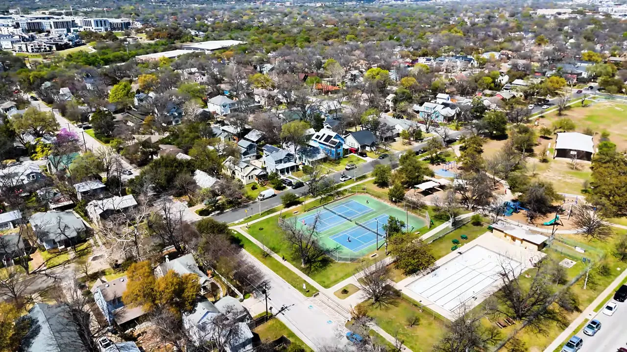 Aerial photograph of Ramsey Park in Rosedale with tennis courts, an empty swimming pool, playground areas and tree-lined residential streets