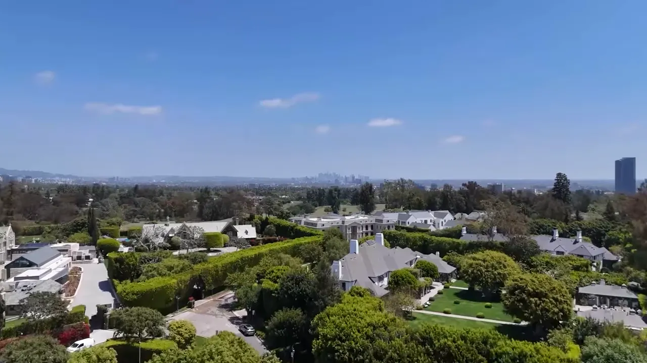 Aerial view of gated luxury homes surrounded by landscaped grounds