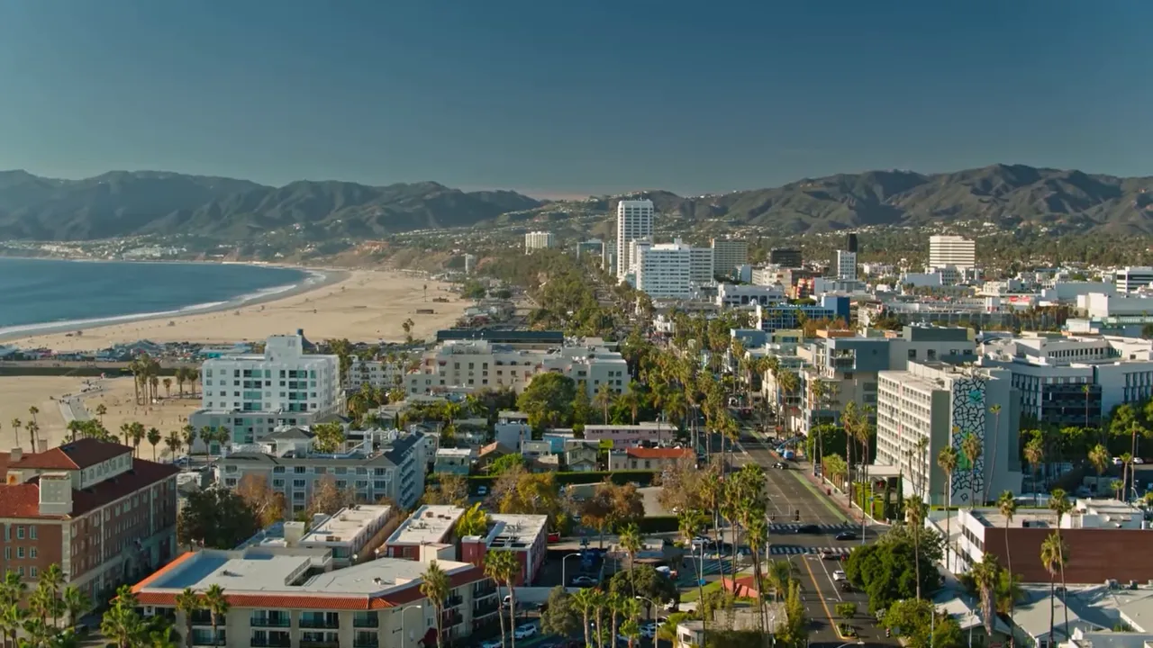 Aerial view of Santa Monica coastline and city skyline with mountains