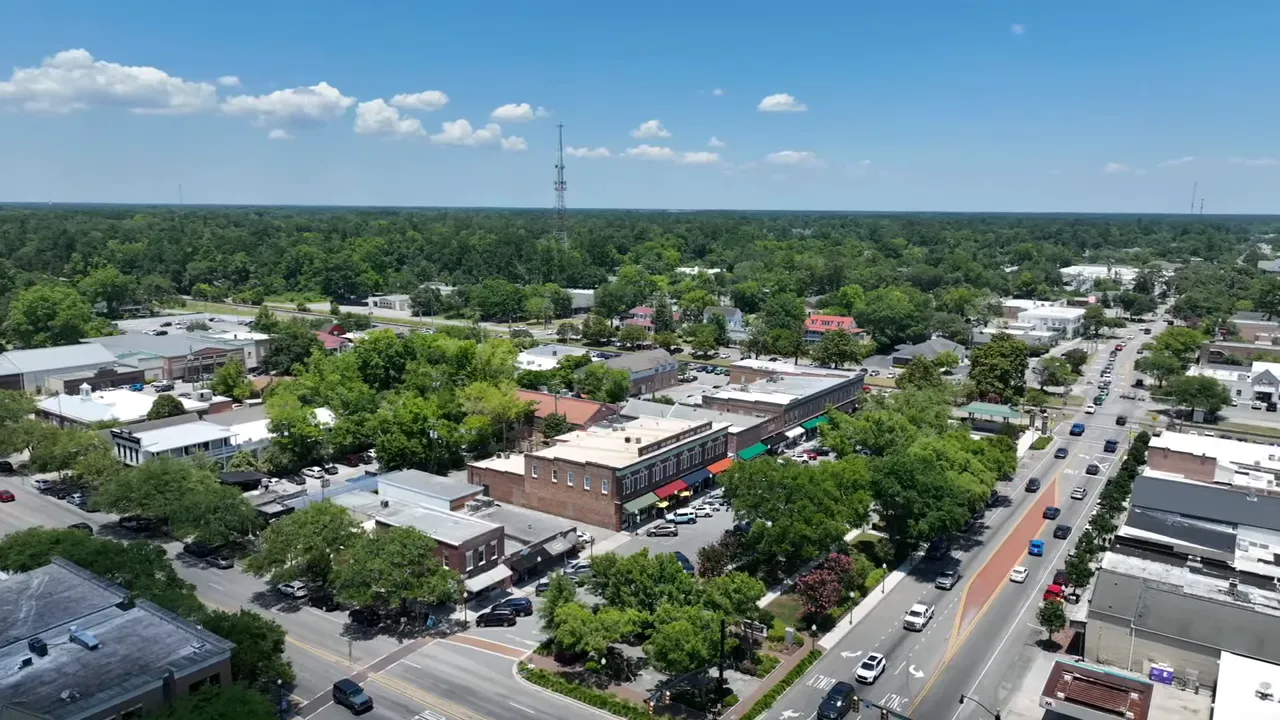 Aerial view of downtown Summerville showing tree-lined streets, small commercial buildings, and light traffic