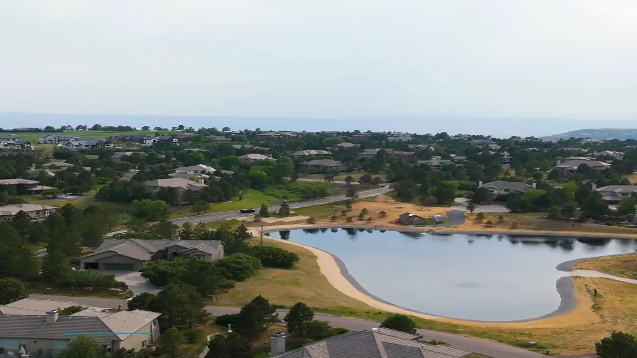 Aerial view of Castle Pines homes around a lake