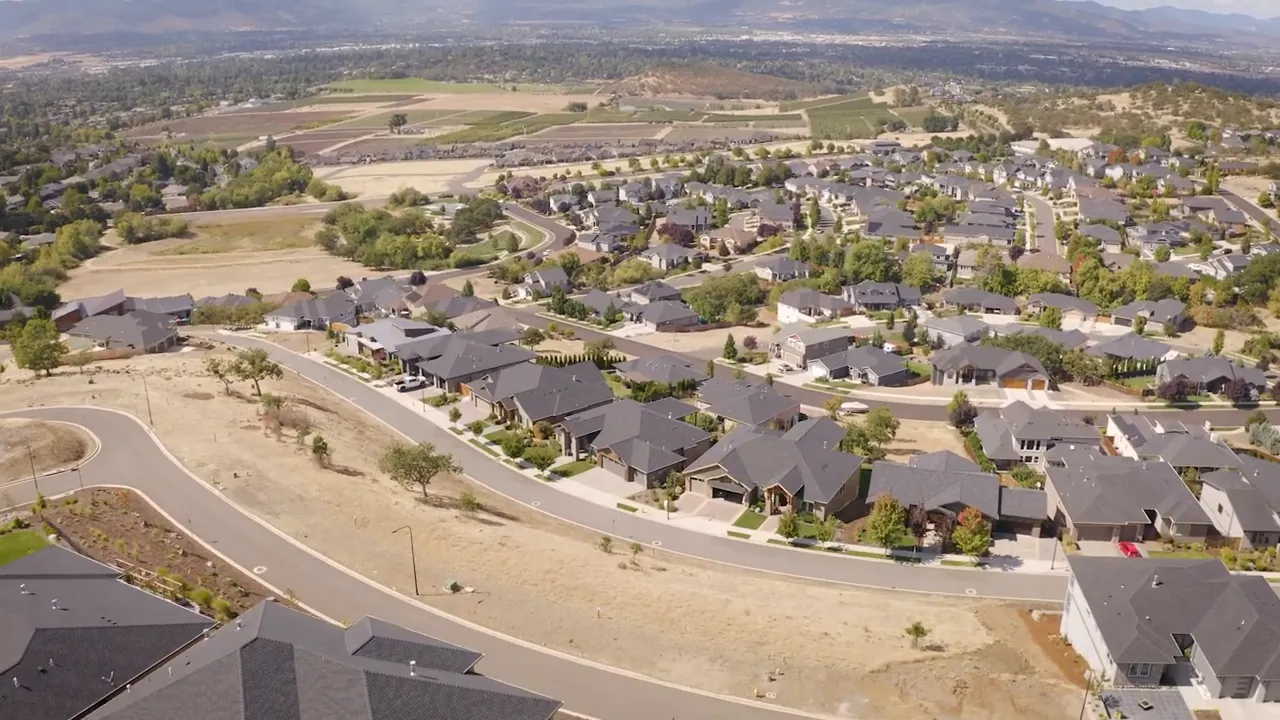 Aerial view of newly built homes, roads and vacant lots in a suburban development