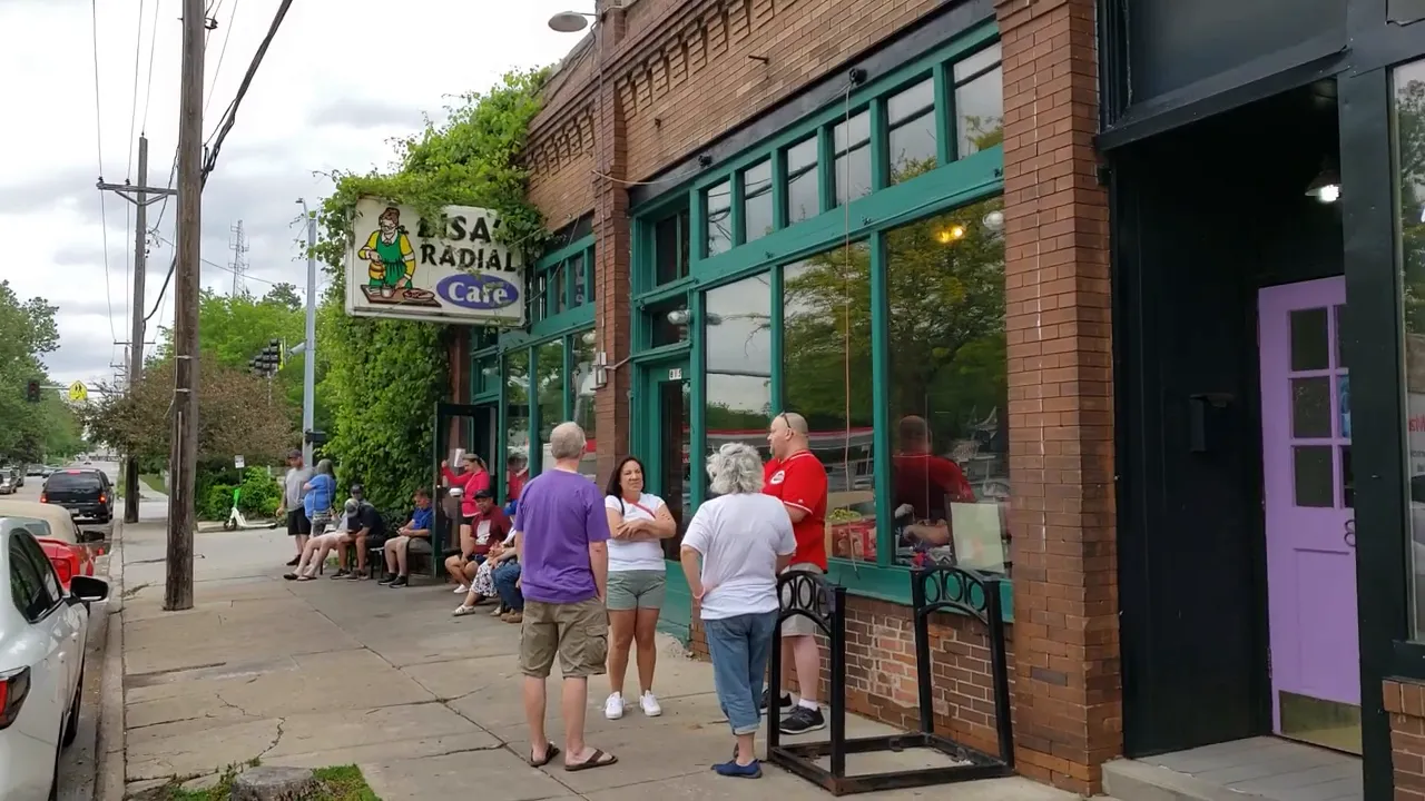Exterior of Lisa's Radial Cafe with people waiting on the sidewalk