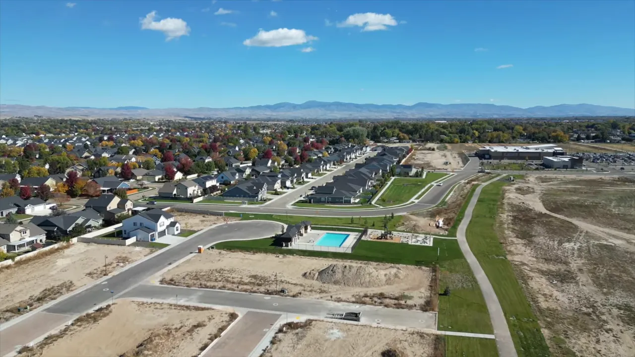 Aerial view of a developing residential community with curved roads and homes near Boise, Idaho