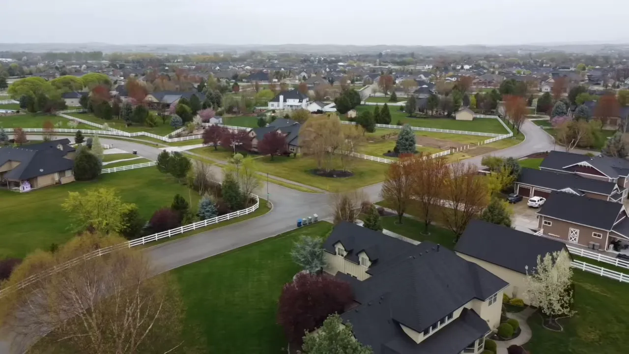 Aerial view of spacious homes and fenced open land in Eagle Idaho