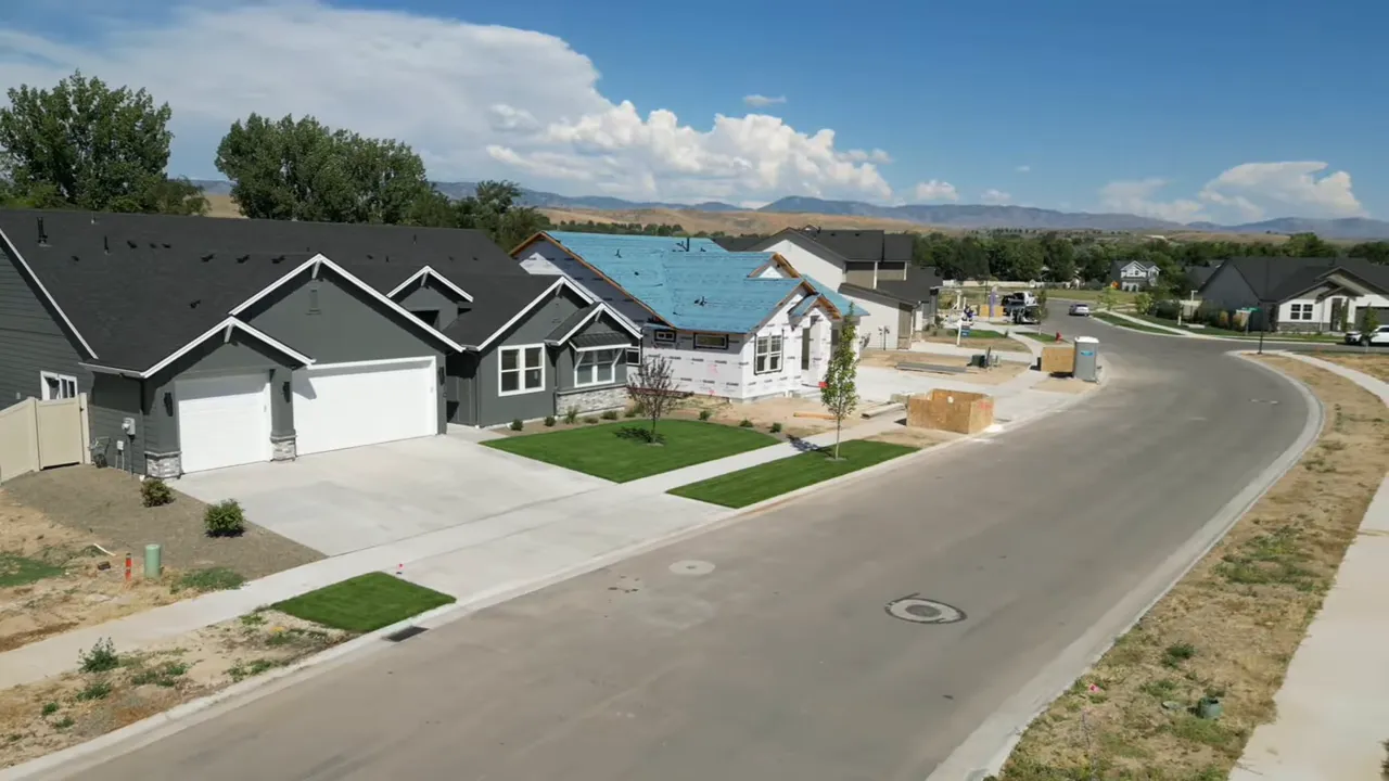 New construction neighborhood with modern homes, sidewalks, and a curved road
