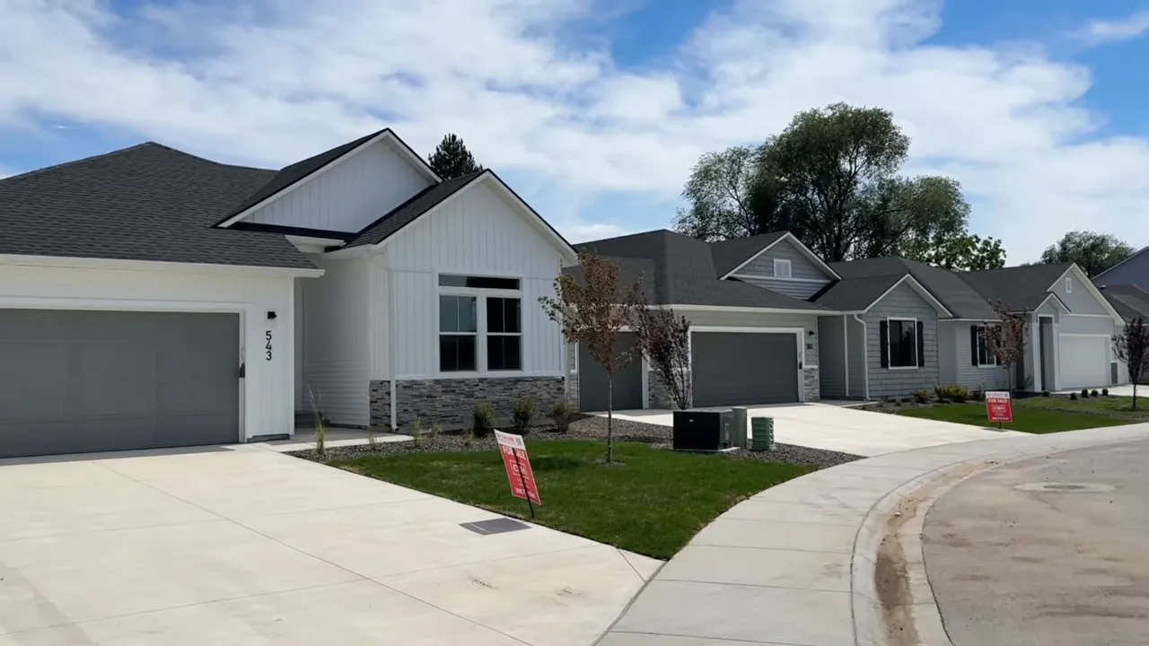 Completed single-family homes along a curved neighborhood street