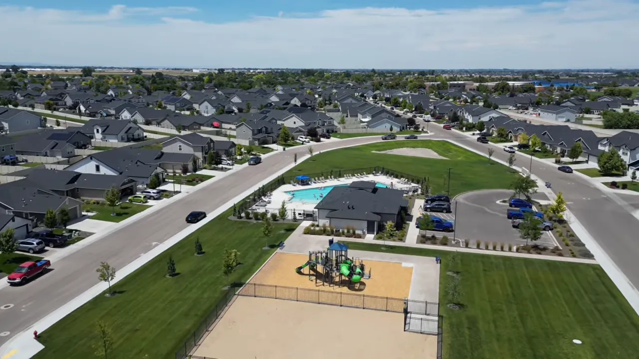 Community pool playground and green space surrounded by newer homes
